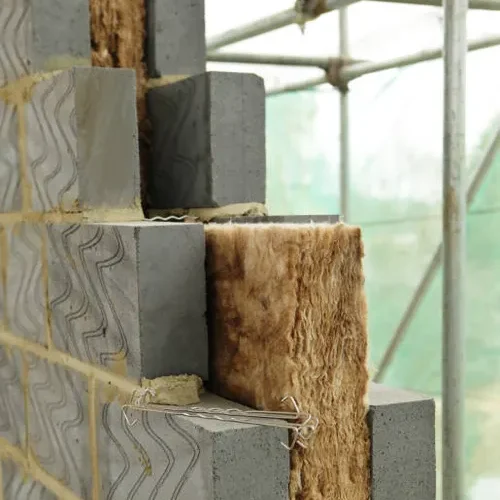 Close-up of stacked building blocks with insulation material between them.